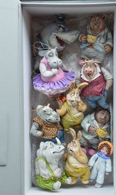 many figurines are in a white box