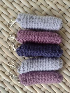 three crocheted keychains sitting on top of a woven basket