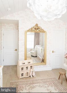 a baby's room with a large mirror and toy house in the middle of it