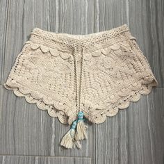 a crocheted shorts with tassels on the side