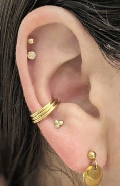 "This clicker hoop is made to create the appearance of three hoops with only one piercing. It fits best worn in a conch piercing in the space where the three hoops can rest toward the bottom of the conch. The hinge is placed for it to fit for the LEFT ear, though if your piercing is in the right ear (as is the case with the model) the hoop can be threaded backwards through the piercing the way a labret post would be threaded. The hinge is attached to the center hoop which is 10mm interior diamet Daith And Conch Earrings, Thick Conch Hoop, Stretched Septum Jewelry, Conch Hoop Jewelry, Earring Placements, Coin Slot Piercing, Conch Piercing Hoop, Gold Conch Hoop, Conch Piercing Jewelry