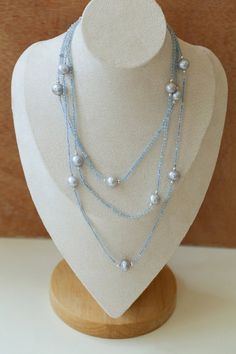 This elegant necklace features a long strand adorned with natural aquamarine and gray pearls, exuding a sophisticated charm. Perfect for adding a touch of refinement to any ensemble, it combines the serene hues of aquamarine with the timeless allure of gray pearls, creating a versatile accessory suitable for both casual and formal occasions. Metal: Recycled Sterling Silver Plated On Brass Gemstone: Aquamarine Pearl: Freshwater Pearls 9-10mm Chain Length: 1400-1450mm Weigth: 29g Sliver Earrings, Gemstone Beaded Necklace, Long Beaded Necklace, Elegant Necklace, Enamel Earrings, Elegant Necklaces, Pearl Grey, Natural Aquamarine, Recycled Sterling Silver