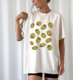 This Gender-Neutral Adult T-shirts item by CheekyBit has 212 favorites from Etsy shoppers. Ships from San Jose, CA. Listed on May 4, 2024 Patchwork Shirt Diy, Martini Shirt, Kawaii Shirt, Martini Olives, Silly Shirt, Olive Shirt, Kawaii Shirts, Food Clothes, Styling Inspiration