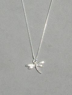 Dragonfly Necklace The dragonfly pendant is silver plated and measures 17mm x 20mm. The dragonfly is dainty, but still shows great detail It is strung on a silver plated tiny 1.3mm curb chain with a lobster clasp closure. Choose the length from the drop down. Silver Dragonfly Necklace, Dragonfly Jewelry, Dragonfly Necklace, Dragonfly Pendant, Jewelry Accessories Ideas, Silver Jewelry Necklace, Funky Jewelry