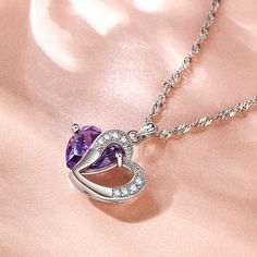 A sparkling tribute to you, this heart necklace is a special look you are certain to adore. Crafted in sterling silver, it features a shimmering purple heart-shaped stone with an open heart-shaped frame. Smaller stones adorns heart frame, adding subtle sparkle. It's a sweet and romantic gift for you or your loved ones.Carat Weight: 5.97 ctStone Size: 10*10 mmStone Type: Jeulia® StoneNumber of Stones: 1 Stone Color: Amethyst PurpleStone Shape: HeartCarat Weight: 0.374 ctStone Size: 1.3,1.5 mmSton Heart Shaped Frame, Amethyst Necklace Pendant, Heart Frame, Purple Heart, Sterling Silver Necklace Pendants, Necklace Online, Amethyst Pendant, Open Heart, Romantic Gift