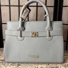 a gray purse sitting on top of a table