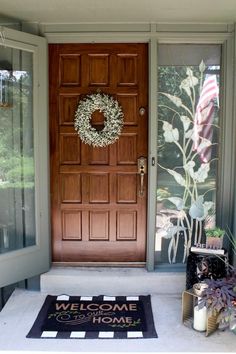 a welcome mat sits on the front porch