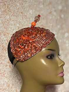 This orange rhinestone-studded piece is accented with a hat pin. Simple, yet stunning. Perfect for church and any other special occasions: tea parties, weddings, etc. Teardrop shaped Length: 6.75 inches Width: 5.15 inches (inches from the widest part) The hat pin may vary and is for decorative purposes only. The hat is affixed to the head via a hatstring. Handmade Gifts for mom, sister, wife, or yourself. Embellished Adjustable Headpieces For Evening, Orange Adjustable Mini Hats For Wedding, Adjustable Orange Mini Hats For Weddings, Adjustable Orange Mini Hat For Wedding, Wedding Mini Hat In Orange With Adjustable Fit, Adjustable Orange Fascinator For Evening, Orange Adjustable Headpieces For Wedding, Adjustable Orange Headpieces For Wedding, Adjustable Orange Mini Hats For Party