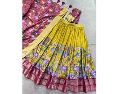 Designer lehenga choli Kalamkari lehenga for women South indian lehenga 3pc set indian lengha Traditional outfit festival lehenga set 🌷Lehenga Choli🌷 Subtle shades, bold heritage: Kalamkari Dola silk charm 🪸 Lehenga(Stitched) Lehenga Fabric : Dola Silk Lehenga Work : Kalamkari Print With Zari Weaving Border  Waist : SUPPORTED UP TO 42 Lehenga Stitching : Stitch With Canvas  Lehenga Closer : Drawstring With Zip Length : 41 Flair : 3.80 Meter  Inner : Micro Cotton Blouse(Unstitched) Blouse fabr Yellow Anarkali Set With Kalamkari Print, Bohemian Fitted Lehenga With Bandhani Print, Fitted Bohemian Lehenga With Bandhani Print, Fitted Bohemian Bandhani Print Lehenga, Floor-length Kalamkari Print Dupatta, Festive Semi-stitched Kalamkari Print Palazzo Set, Fitted Kalamkari Print Sets For Diwali, Floor-length Kalamkari Dupatta For Diwali, Yellow Maxi Length Sets For Navratri