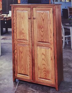 a large wooden cabinet sitting on top of a floor