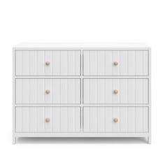 a white dresser with four drawers and two knobs on the front, one drawer open