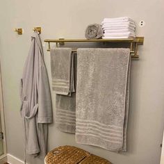 towels are hanging on the towel rack in this bathroom