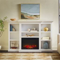 a living room with a fire place and a painting on the wall