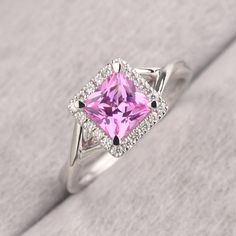 ◆ The ring is handcrafted from sterling silver and decorated with a dazzling 6*6 mm pink sapphire and CZs. It is suitable for engagement/anniversary/daily occasion. ◆ Production Description: Main stone Type: Lab Pink Sapphire Main Stone Shape: Princess Cut Main Stone Size: 6*6 mm(1.37ct) Side stone: CZ Metal: 925 Sterling silver - Other options available in the drop down menu ◆ Customization: √Free for Add Engraving √Other Metal Type Available √Other Gemstones & Shapes Available √Personalization Brilliant Cut Pink Sapphire Diamond Ring In White Gold, Classic Pink Sapphire Diamond Ring In White Gold, Classic White Gold Ring With Pink Sapphire, Classic White Gold Diamond Ring With Pink Sapphire, Classic White Gold Pink Sapphire Diamond Ring, Formal Pink Sapphire Diamond Ring With Halo Setting, Cubic Zirconia Princess Cut Halo Ring, Princess Cut Cubic Zirconia Halo Ring, Pink Brilliant Cut Sapphire Ring In Fine Jewelry Style