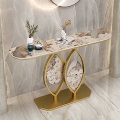 a white marble table with gold accents and two mirrors on the wall above it, along with other decorative items