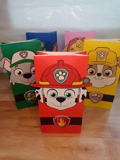 four fireman dogs are on the front of these small boxes, each with a different design