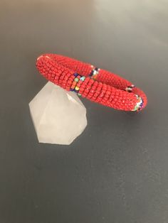 Southwestern designed seed bead bangle with interchanging red and multi-color blocks  Measures 2.5" across the inside of the bangle 7 1/4" measured on the mandrel Vintage Clothing & Jewelry with a Southwest Flair Check out my shop for more jewelry and clothing! https://www.etsy.com/shop/sierramadrevintage Adjustable Red Southwestern Bracelets, Southwestern Style Adjustable Red Bracelets, Southwestern Style Red Beaded Bracelets For Gift, Southwestern Style Red Beaded Bracelet As Gift, Red Beaded Bracelets With Spacer Beads For Festival, Festival Red Beaded Bracelets With Spacer Beads, Red Faceted Beads Bracelet For Festival, Red Stretch Bangle Bracelet With Colorful Beads, Adjustable Red Bead Bangle