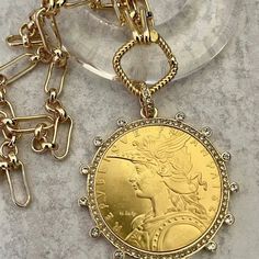 Gold Coin Necklace Beautiful reproduction vintage coin pendant, French Madagascar coin in a bezel with cubic zirconia stones. The bale attached to the coin is also encrusted with CZ stones. The coin is 22k gold plated and elegantly hangs from a multi link gold plated brass chain and a rope design spring lock clasp. The spring lock closure not only makes it easy to open and close the necklace for those with difficulty but adds to the creativity of the jewelry piece. Please see photograph of how t Gold Coin Necklace Layered, Coin Frame, Photographing Jewelry, Faberge Jewelry, Easy Jewelry, Gold Coin Necklace, Coin Pendant Necklace, Coin Earrings, Rope Design