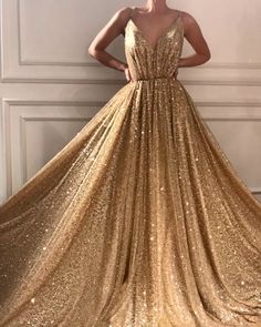 Details  - Gold color - Sparkling tulle fabric  - Ball-gown style with v-neck  - For special occasions Elegant Gold Tulle Evening Dress, Champagne Tulle Gown For Gala, Glamorous Gold Tulle Dresses, Gold V-neck Gown For Prom, Champagne V-neck Gown For Prom, Champagne Tulle Dress For Gala, Gold Tulle Gown For Gala, Elegant Gold Tulle Gown, Glamorous Tulle Gown With V-neck