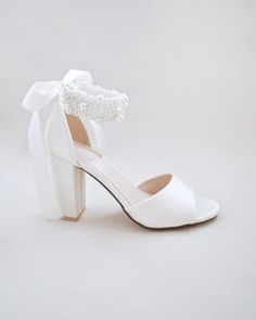 Satin block heel wedding sandals adorned with all over pearls ribbon strap . Elegance and feminine inspired wear for your special day. The delicate pearl beads are placed to create a graceful classic style. Simple and easy wear for bridal wear, bridesmaids, holiday party, wedding parties, and any special occasions. The light blue color can easily be your something blue.DETAILS:HEELS: 4 inchesCOLORS AVAILABLE: Ivory, White and Light BlueUPPER: Synthetic upper and liningMATERIALS: Manmade outsoleO Purple Wine, Christmas Gift Shop, Wedding Sandals, Wedding Parties, Mary Jane Heels, Bride Shoes, Boot Pumps, T Strap Sandals, Grey Shoes