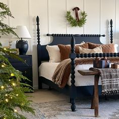 a bedroom decorated for christmas with wreaths on the headboard and foot board, along with other holiday decorations