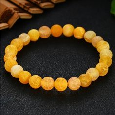 -Yellow Agate Bead Bracelet -8mm Natural Yellow Agate Beads -On Elastic Band, Slides On & Fits Most Wrist Sizes -Never Worn -Comes In A Black Drawstring Bag, Great For Giving As A Gift (Or Storing When Not Wearing) Yellow Agate Is A Variety Of Chalcedony Known For Its Warm, Sunny Hues And Distinctive Banding Patterns. It Is Believed To Promote Mental Clarity, Enhance Concentration, And Foster A Sense Of Optimism. Traditionally, Yellow Agate Is Thought To Bring Emotional Balance And Stability, Aiding In Overcoming Negative Emotions And Encouraging A Positive Outlook. Its Grounding And Soothing Energies Are Also Said To Improve Self-Confidence And Motivation. Adjustable Yellow Beaded Bracelets With Natural Stones, Yellow Beaded Bracelets With Natural Stones For Gifts, Yellow Natural Stones Beaded Bracelet, Elegant Yellow Stretch Bracelet With Round Beads, Elegant Yellow Beaded Stretch Bracelet, Elegant Yellow Stretch Bracelet, Yellow Beaded Healing Bracelets, Adjustable Yellow Crystal Bracelet With Gemstone Beads, Yellow Gemstone Beads Crystal Bracelet For Gift