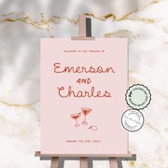 an easel with a card on it that says, welcome to the wedding of emerson and charles