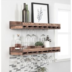 two wooden shelves with wine glasses and bottles on them in front of a tiled wall