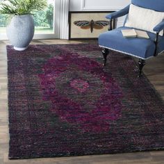 a purple rug with a blue chair in the background