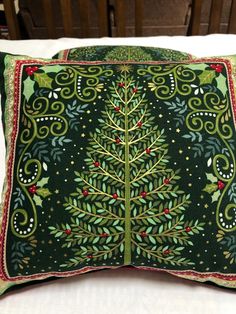 a decorative pillow with a christmas tree on it