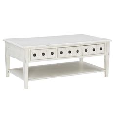 a white coffee table with four drawers