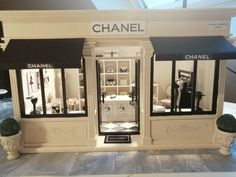 a chanel store front with black and white awnings on the windows display