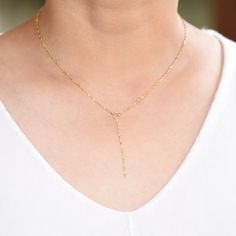 "14k Gold Y Necklace. 14K sparkle chain necklace. 14k delicate y necklace. This necklace is beautiful and delicate. The necklace will arrive in a gift box, ready for delivery. 14K gold necklace 14K gold drop chain (The picture in the listing is 2\") All components are 14k gold Please read our policies before you place your order. https://www.etsy.com/shop/SashJewelry/policy?ref=shopinfo_policies_leftnav To see other bracelets click here https://www.etsy.com/shop/SashJewelry?section_id=12354075&a 14k Gold Filled Lariat Necklace For Gift, Fine Jewelry Yellow Gold Backdrop Necklace With Delicate Chain, Delicate 14k Gold Chain Necklace, Fine Jewelry Backdrop Necklace With Delicate Chain For Gifts, Fine Jewelry Lariat Necklace With Delicate Chain, Minimalist 14k Gold Lariat Chain Necklace, Dainty 14k Gold Long Drop Necklaces, Dainty Long Drop 14k Gold Necklace, Dainty Lariat Necklace With Delicate Chain