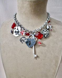 This one of a kind necklace features vintage charms and glass beads and crystals.  The theme is card playing and winning!  In the center is a lock and key to lock it away! The lucky necklace is adjustable from a choker to 20" long.  The drop is 2 1/2". If you would like more info or pics I am happy to help :) Skull Choker, Red Dice, Vintage Assemblage Necklace, Card Playing, Lucky Necklace, Vintage Assemblage, Assemblage Necklace, Key Lock, Necklace Silver