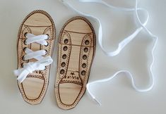 a pair of wooden shoes with white laces