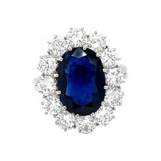 This 18K white gold lovely ring is from our Timeless Collection. It is made of a beautiful siam blue oval shape sapphire 4.80 Carat decorated by 12 round shape natural white diamonds in total of 2.48 Carat. Total metal weight is 6.5 gr. Extraordinary piece for any occasion! The Timeless Collection was inspired by the endless elegance and sophistication of classic high-jewelry, eternising it’s beauty and presenting a selection of classy designs. The intense colours stones give the collections aut Luxury Jewelry Store, Sapphire Cocktail Ring, Fancy Rings, Diamond Cocktail Ring, White Gold Sapphire, Contemporary Ring, Blue Sapphire Diamond, Diamond Cocktail Rings, Modern Ring