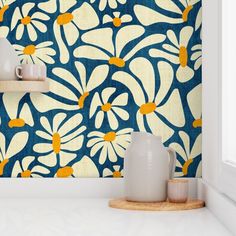 a blue and white wall with yellow flowers on it