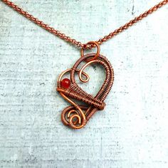 "Carnelian Heart Necklace, wire wrap copper pendant, unique stone jewelry, 7th anniversary gift for wife, natural gemstone, gift for women Copper pendant is handmade using a wire wrapping technique. 1 carnelian natural gem stone agate bead - reddish-orange. Wire wrapped pendant is darkened and polished for a vintage, antiqued look. Approximately 1\" x 1.5\" diameter pendant with solid copper chain, rolo style, 2.6mm x 2.6mm x .89mm round links, copper lobster claw clasp. Chain is darkened and polished for a vintage,  antiqued look. artisan jewelry for women and men designed and handcrafted by Rocky Road Jewelry" Wire Wrapping Techniques, 7th Anniversary Gifts, Anniversary Gift For Wife, 7th Anniversary, Reddish Orange, Anniversary Gifts For Wife, Copper Pendant, Copper Chain, Copper Pendants