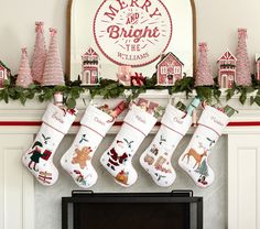 christmas stockings hanging from the mantel in front of a fireplace