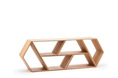 a wooden shelf with three shelves in the shape of hexagons