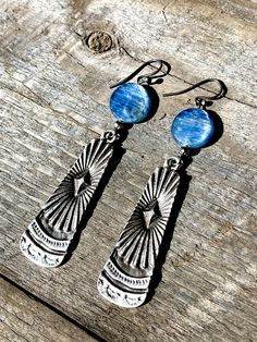 These Oxidized Silver Paddle earrings have a unique Southwestern design and true Western feel. Offering two different gemstone options: * Coin Red Coral * Coin Kyanite (beautiful hues of blue, bronze, and green) Total length = 2.5 inches Sterling Silver ear wire! Bohemian Etched Teardrop Jewelry, Southwestern Style Metal Drop Earrings, Southwestern Style Nickel Free Drop Earrings, Nickel Free Southwestern Drop Earrings, Nickel-free Southwestern Drop Earrings, Nickel-free Adjustable Southwestern Earrings, Southwestern Style Drop Earrings, Southwestern Metal Earrings For Gift, Southwestern Style Metal Earrings For Gift