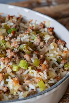 a white bowl filled with rice and vegetables