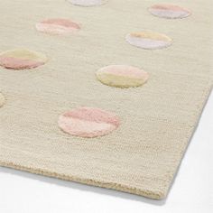 an area rug with pink and white circles on the top, along with several smaller dots