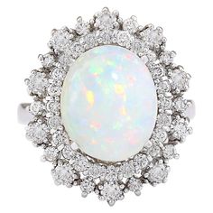 an opal and diamond cluster ring, by van cleef in white gold