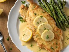 chicken with lemon sauce and asparagus on a plate