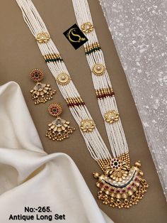 Description :- Indian Jewelry Necklace Set/ South Indian Necklace / Bollywood Ethnic Copper Necklace Earring Set/ Southindian Gold Plated Necklace Set Gift yourself a royal look with this perfectly crafted kundan necklace set from Manalisstudio. Crafted with high quality kundan stones and pearls, it is impressive in design. The green enamel artwork adds perfect texture to the design. Perfect for weddings and festivities, this antique necklace set should be put on with your favorite sari or lehen Indian Jewelry Sets Gold, South Indian Necklace, Indian Necklace Set, Antique Necklace Set, Long Pearl Necklaces, Pearl Necklace Set, Indian Necklace, Kundan Necklace, Box Making