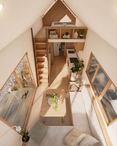 an aerial view of a living room and dining area in a tiny cabin style home