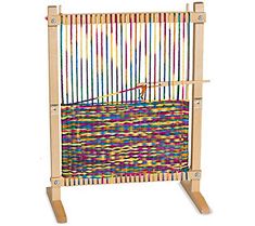 a weaving machine with wooden handles and colorful yarns on it's back end