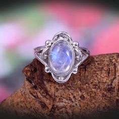 "This Sterling Silver Ring features an Elegant Art With Natural Rainbow Moonstone Gemstone. The cavity is made from genuine solid 925 sterling silver and stamped as S925. This Jewelry is Lead free. ITEM DESCRIPTION Item Code: JARG14 Metal: 925/92.5 Sterling Silver Gemstone: Genuine Natural Rainbow Moonstone Cabochon (Handmade) Gemstone Shape: Oval Gemstone Quality: AAA+ Gemstone Size: 8X12 MM Ring Length: 17 MM Ring width: 14 MM Weight: 5.46 gm **Keep the jewelry away from direct heat, water, pe Bohemian Silver Moonstone Ring, Silver Bohemian Moonstone Ring, Bohemian Moonstone Open Ring Jewelry, Bohemian Moonstone Crystal Ring With Natural Stones, Bohemian Moonstone Crystal Ring With Gemstone, Bohemian Sterling Silver Moonstone Open Ring, Bohemian Silver Opal Open Ring, Bohemian Silver Open Opal Ring, Bohemian Cabochon Moonstone Ring