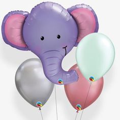 an elephant holding three balloons in it's trunk